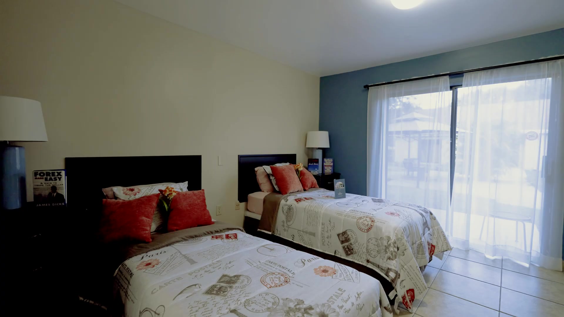 Bright private bedroom suite at Colonial Gardens Residences assisted living in Lauderhill FL with twin beds and natural light