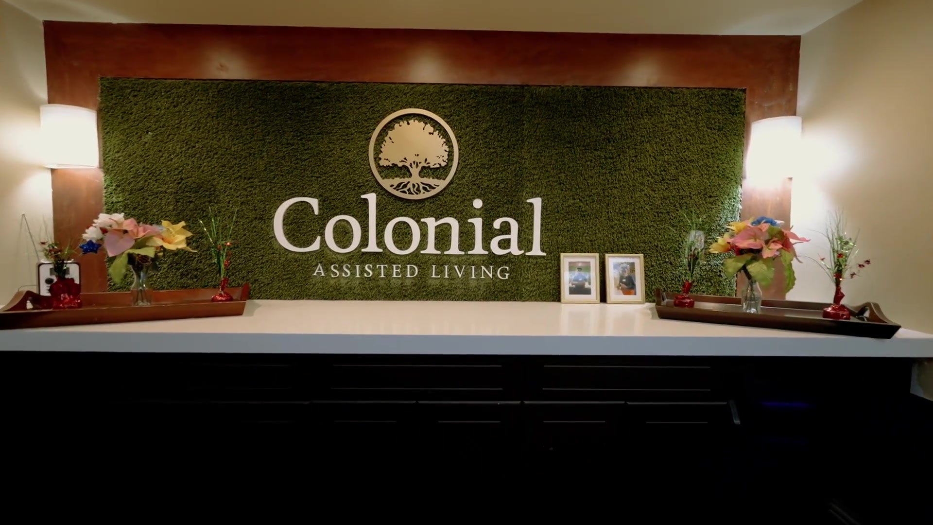 Colonial Gardens branded lobby wall with moss design — Colonial Gardens Residences Lauderhill FL